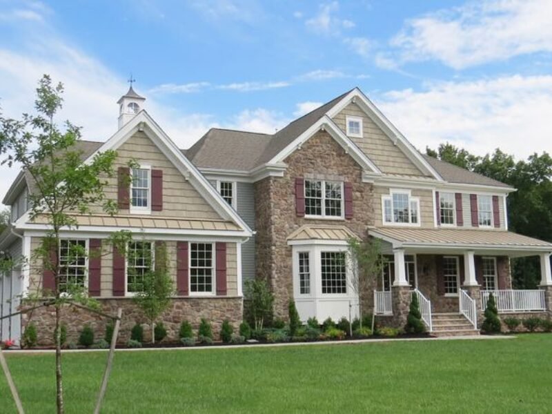 Street view of a large brick and siding home with a new roof in Middletown, NJ.