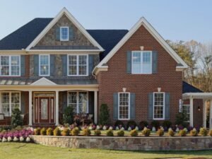 Street view of a large brick home showcasing a new roof installation in Middletown, NJ.